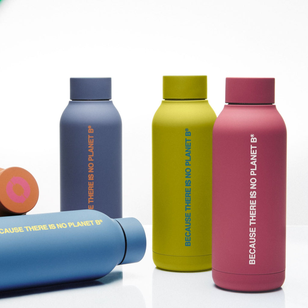 Four Ecoalf bottles in blue, green, pink, and grey, featuring "BECAUSE THERE IS NO PLANET B" text.
