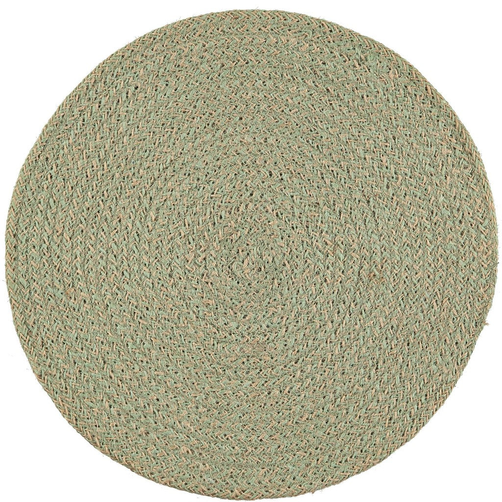 Round woven placemat in pale green and beige.