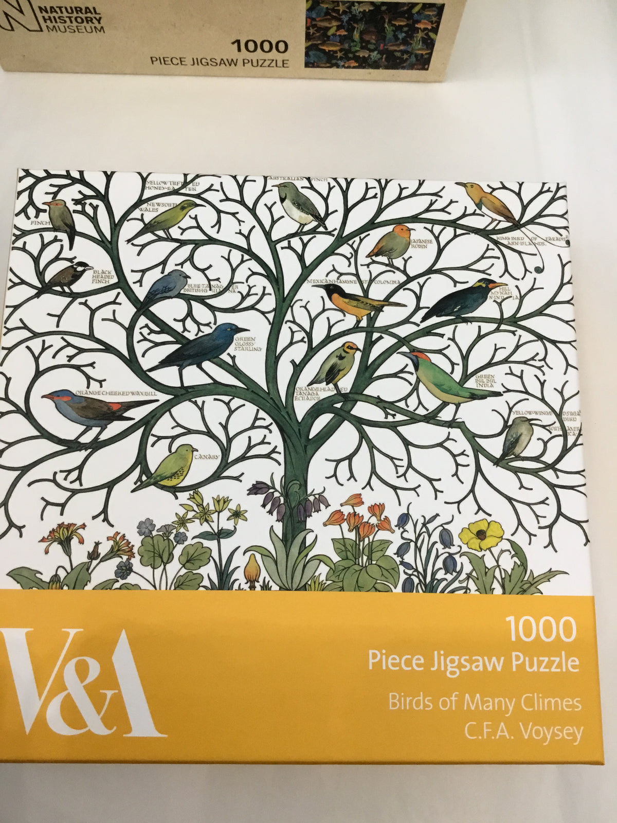 1000-piece jigsaw puzzle depicting various birds on a tree, titled "Birds of Many Climes" by C.F.A. Voysey.