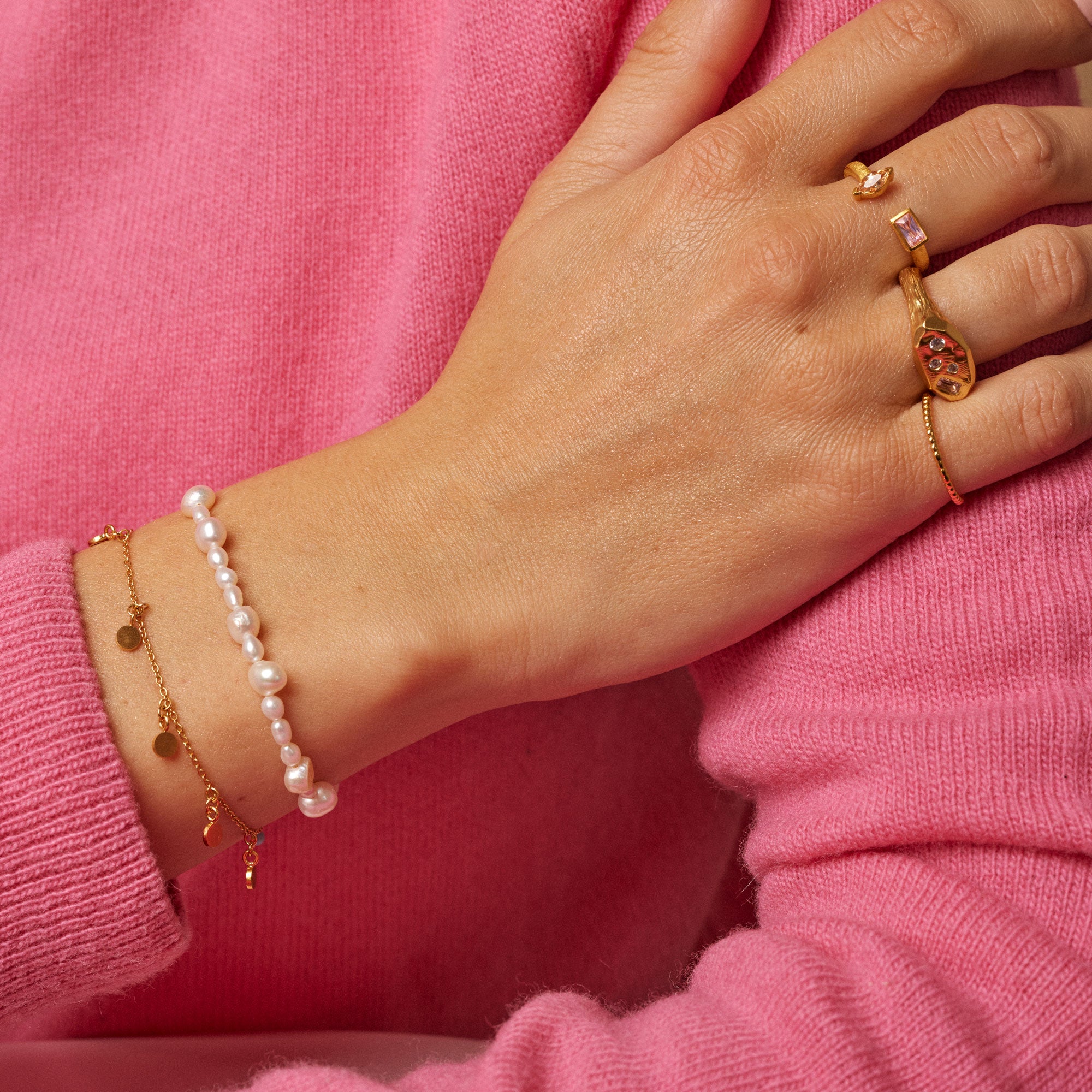 Gold and pearl bracelet set.  Features a pearl bracelet and a delicate gold chain bracelet with small gold disc charms.