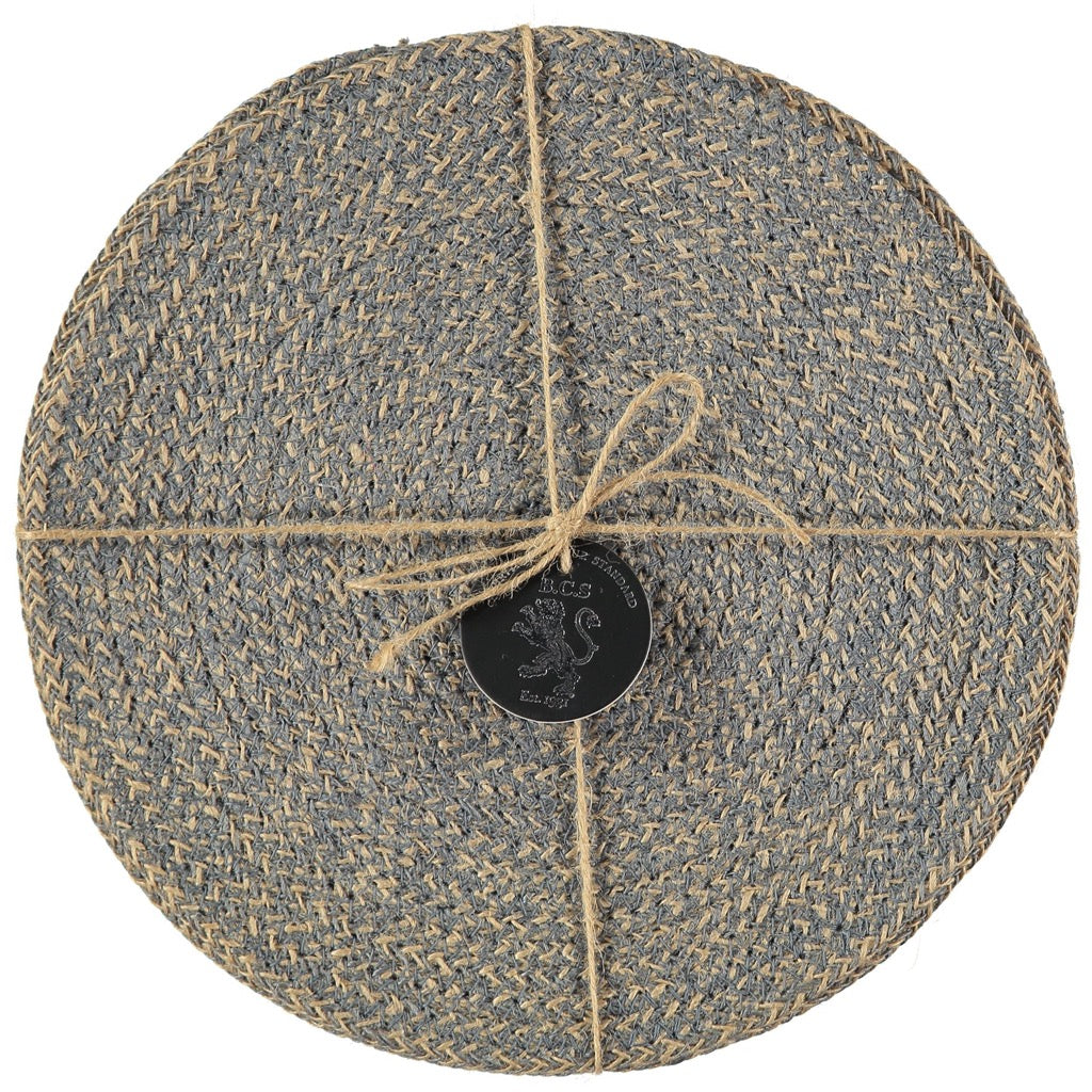 Set of round jute placemats in blue and beige, tied with twine.