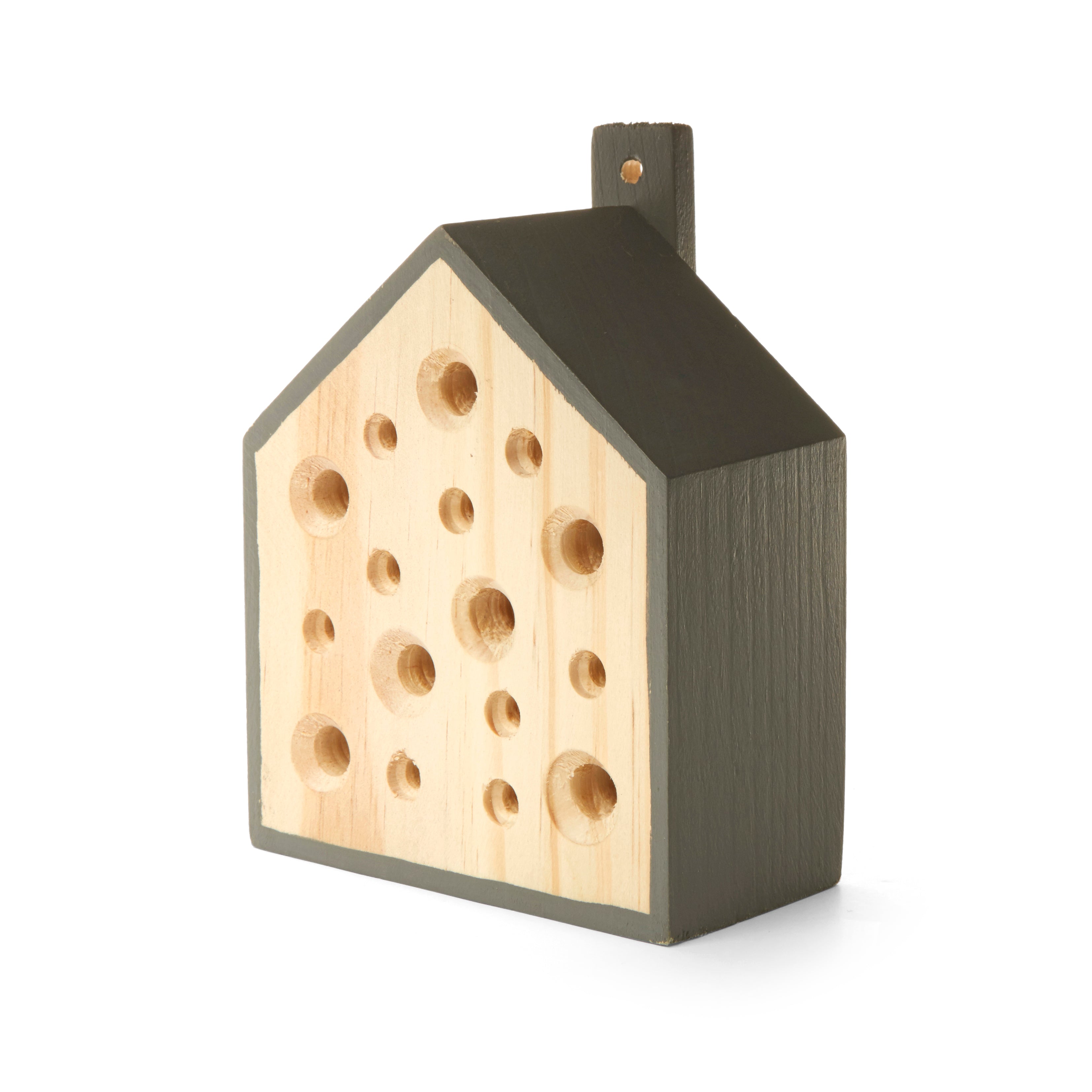 Wooden insect house shaped like a house with a dark gray roof and numerous holes in the light wood front.