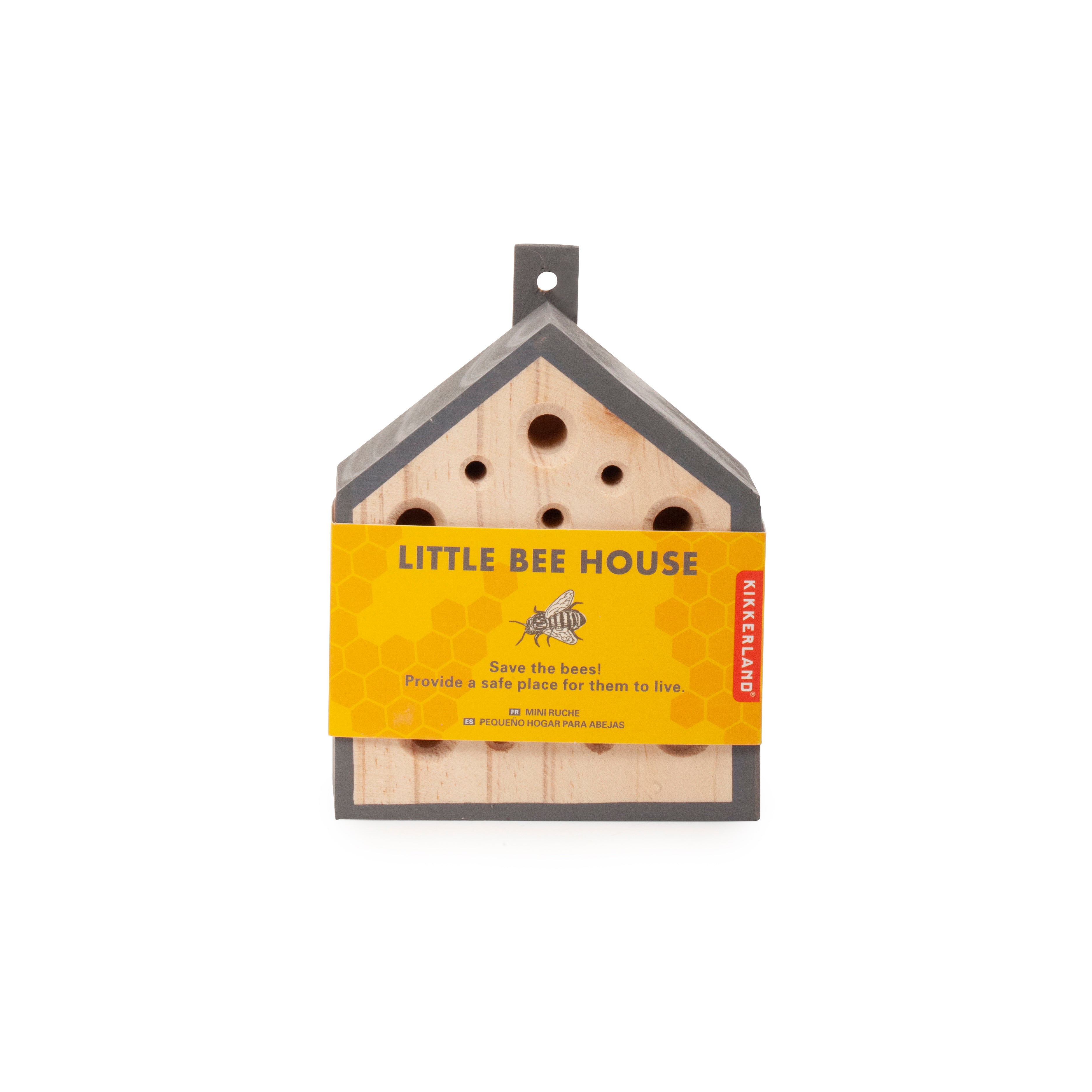Small gray and light brown wooden bee house with multiple holes, designed to provide shelter for bees.