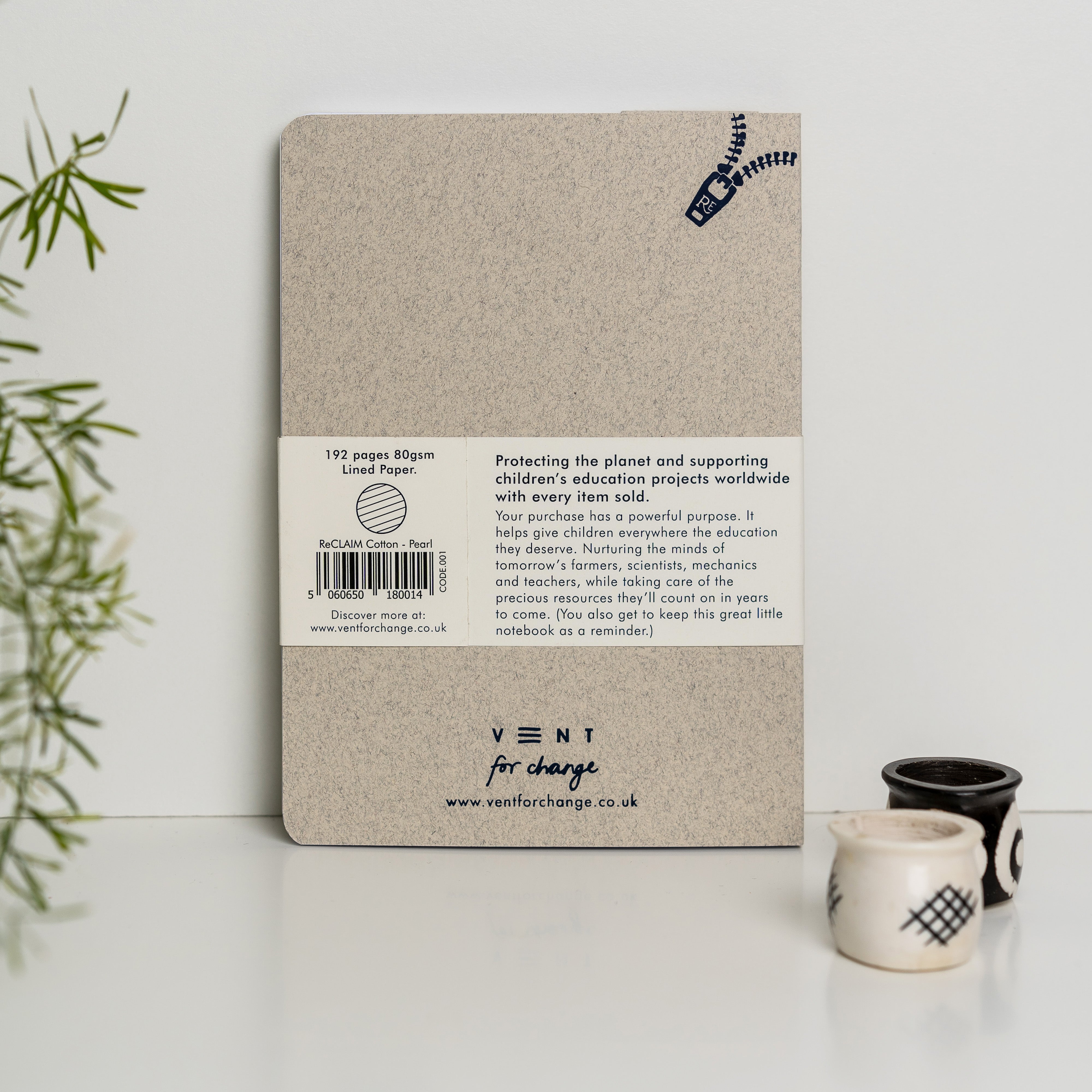 Beige notebook with 192 lined pages, made from reclaimed cotton paper; features a zipper design and supports children's
