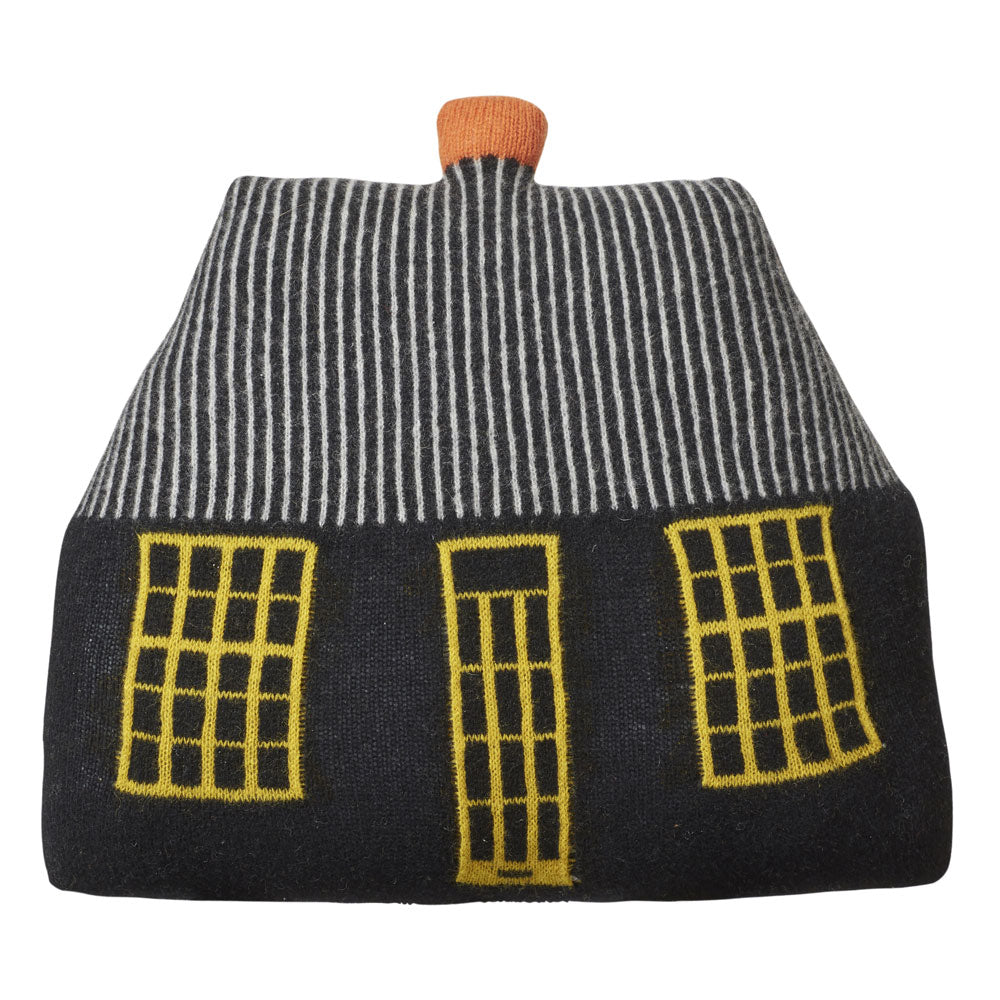 A cozy, knitted pouch by Donna Wilson in black with white stripes, featuring yellow windows and an orange roof top.