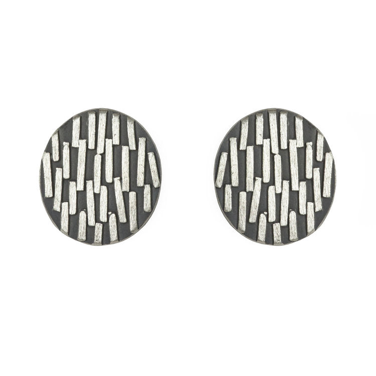 Pair of round silver earrings.