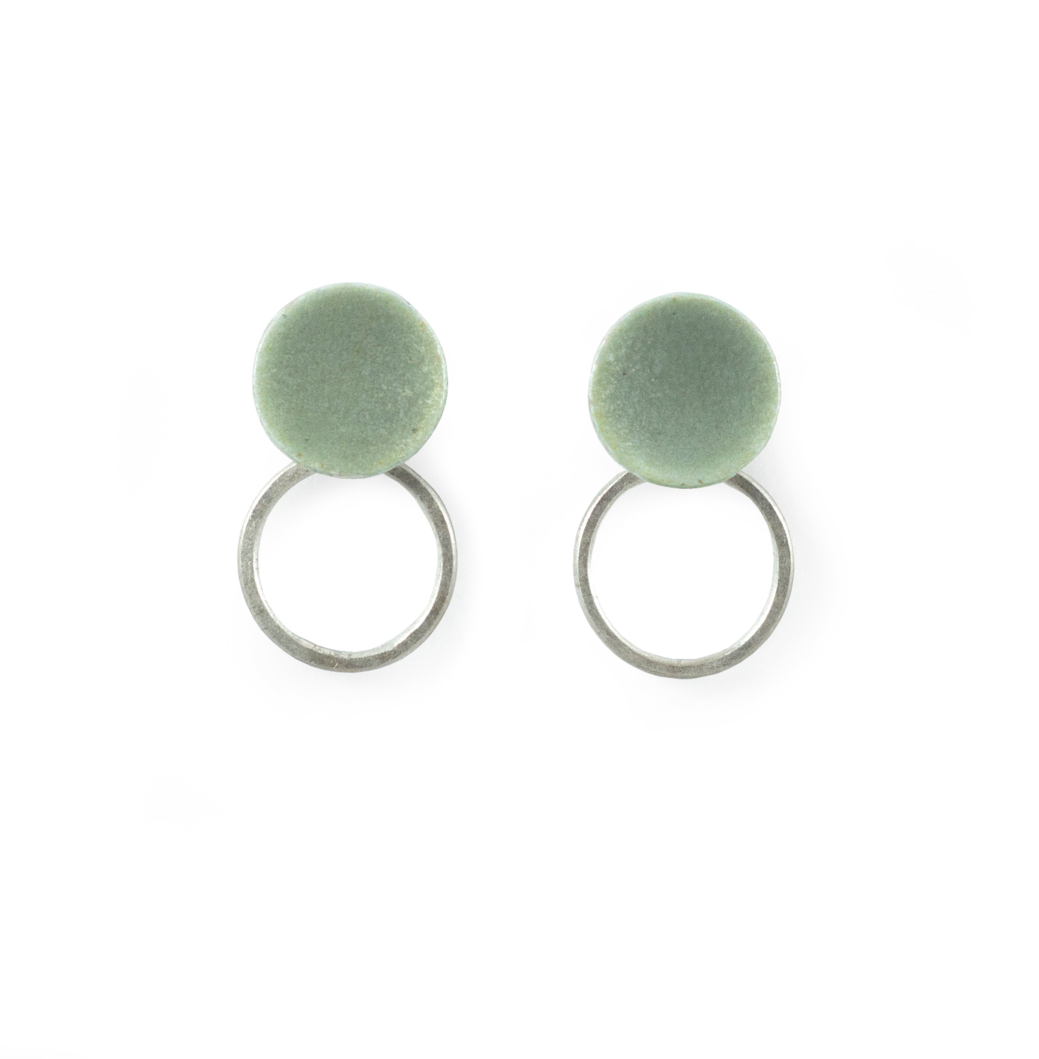 Pair of minimalist earrings; pale green circular discs atop silver hoops.