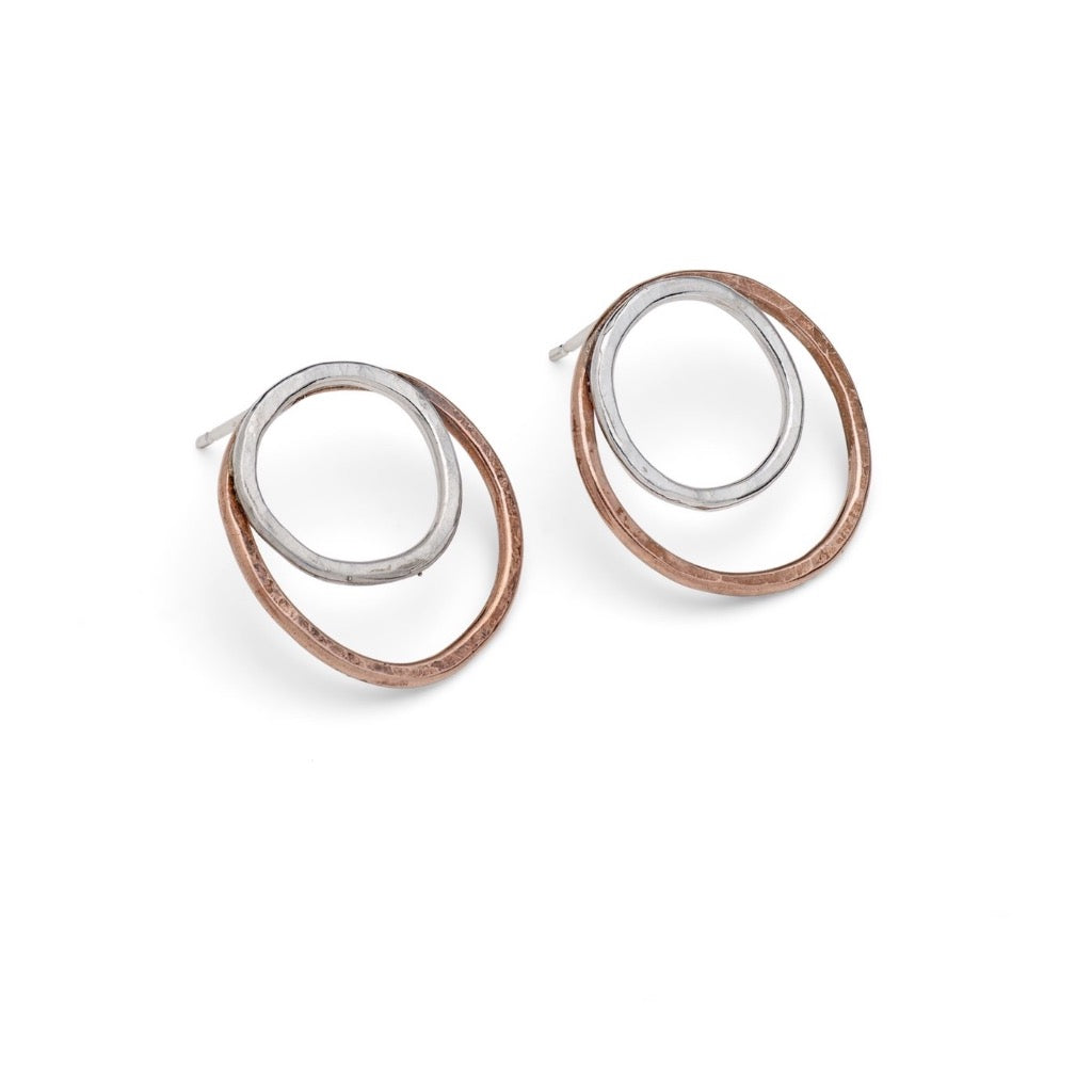 Pair of silver and copper double-circle stud earrings.