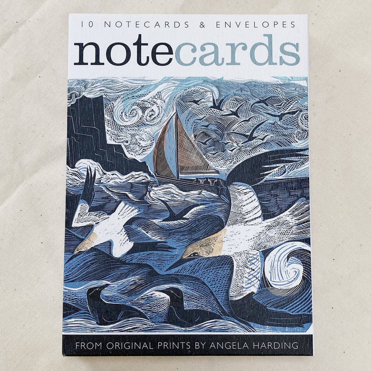 Pack of 10 notecards and envelopes featuring a blue and white linocut print of birds and a sailboat at sea.