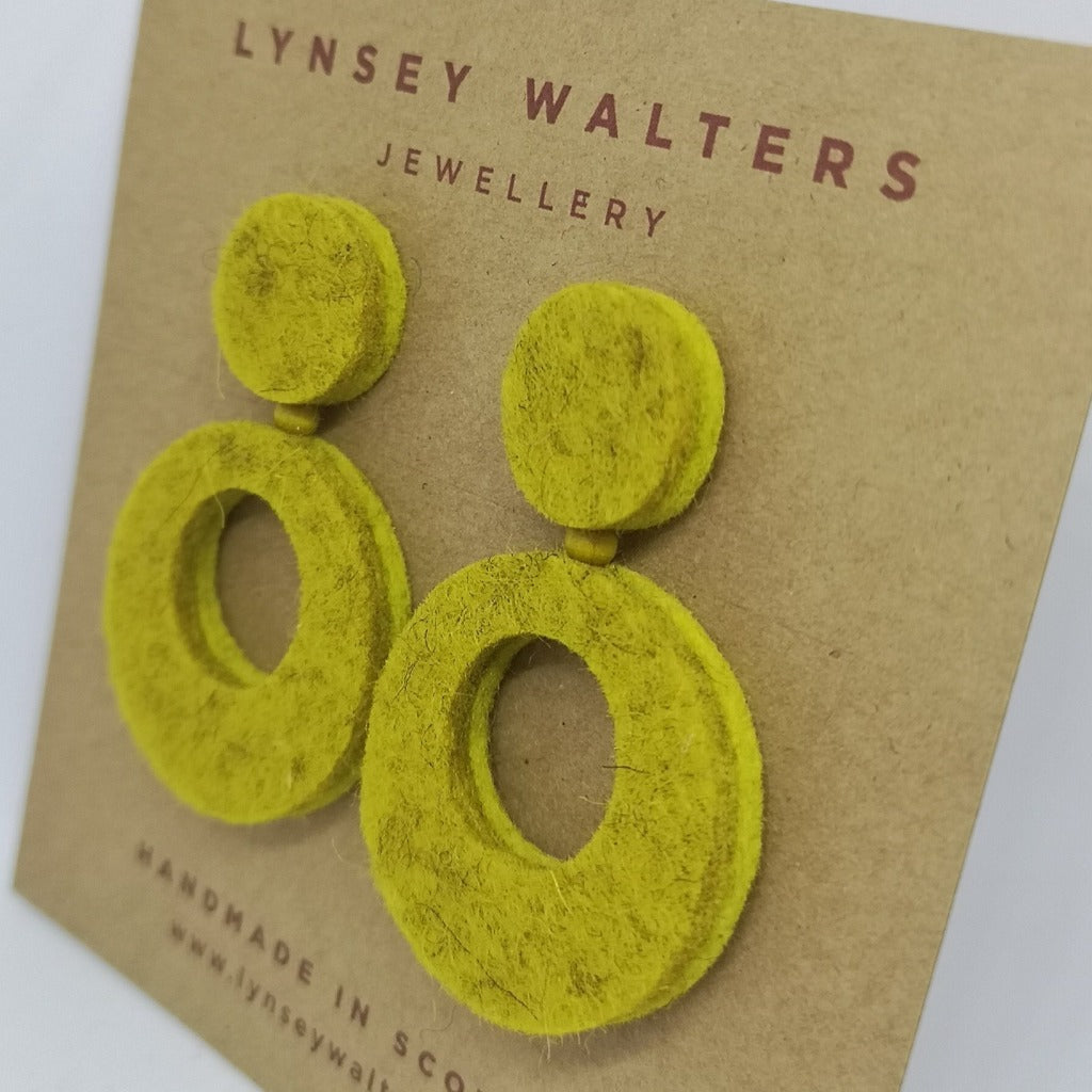 Pair of lime green felt earrings.  Each earring features a small circle atop a larger, hollow circle.