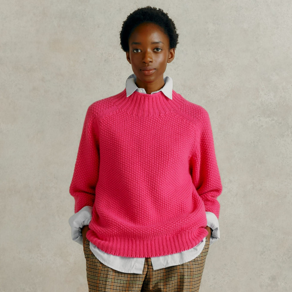 a female model wearing checked trousers and a Harley of Scotland Super Fine Moss Stitch Jumper - Punk
