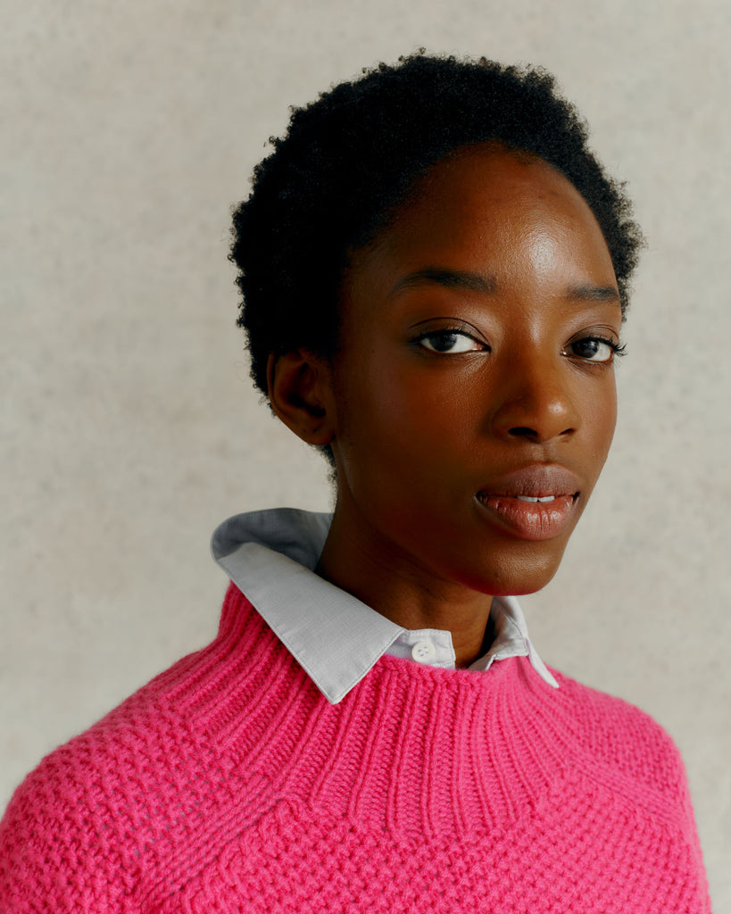 headshot of a female model wearing a blue collared shirt and a Harley of Scotland Super Fine Moss Stitch Jumper - Punk