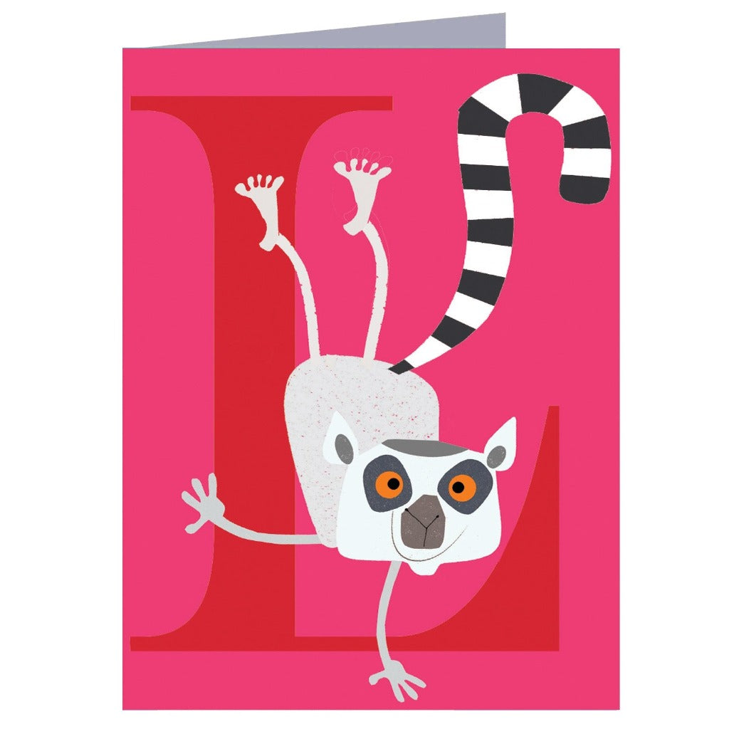 Greeting card featuring a ring-tailed lemur hanging upside down from a large red letter L on a pink background.