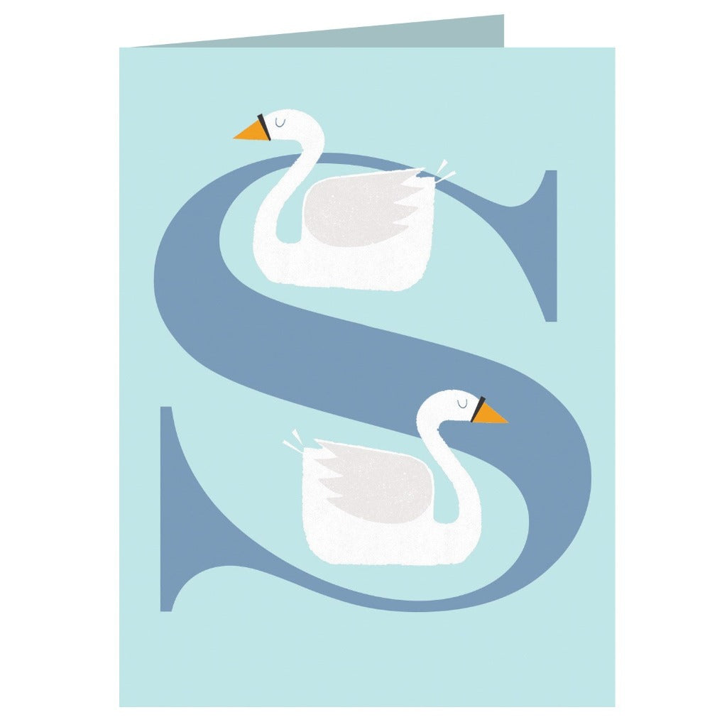 Two white swans depicted on a pale blue greeting card, forming the letter 'S' with a darker blue outline.