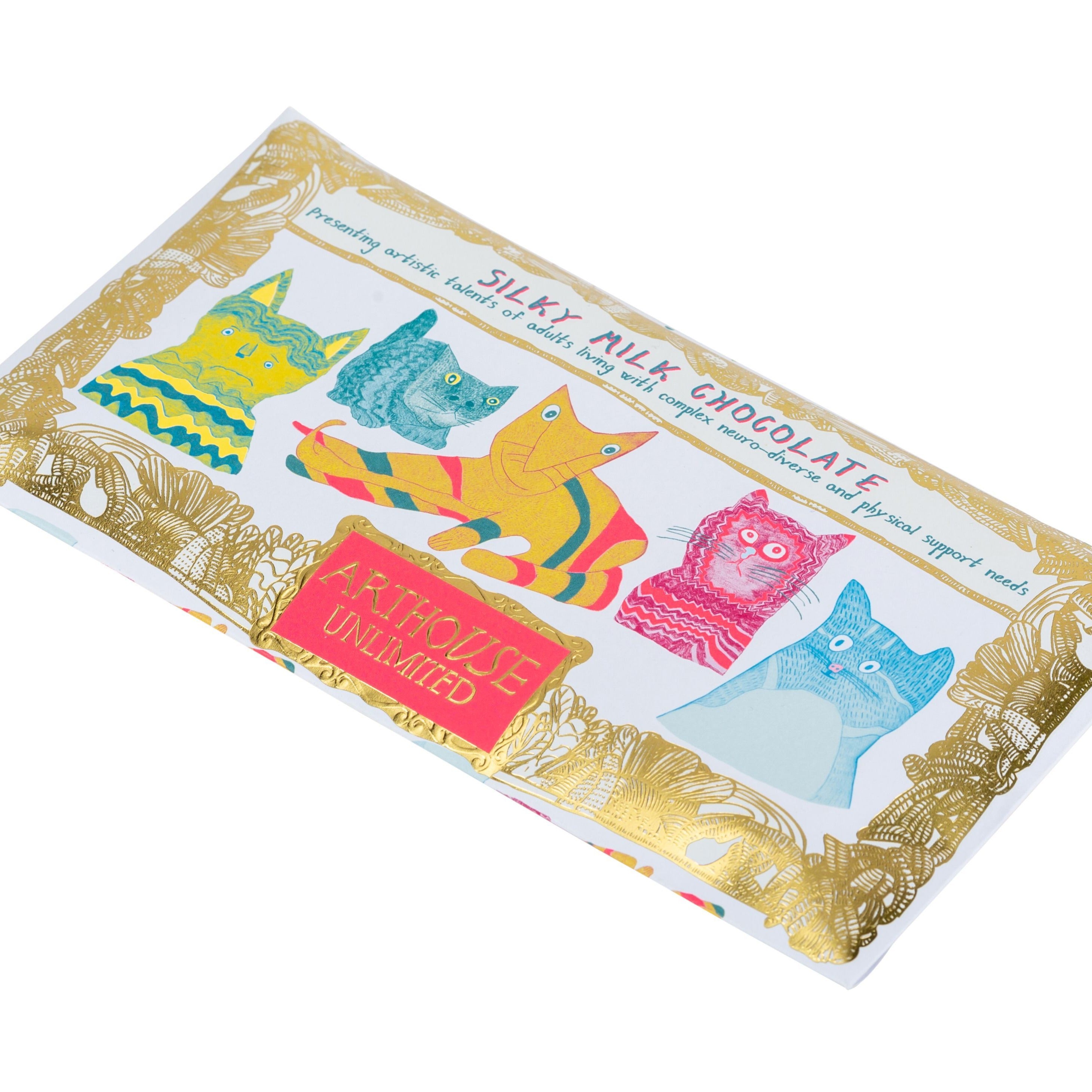 Silky Milk Chocolate bar wrapper featuring colorful illustrated cats and gold foil detailing. ArtHouse Unlimited branding.