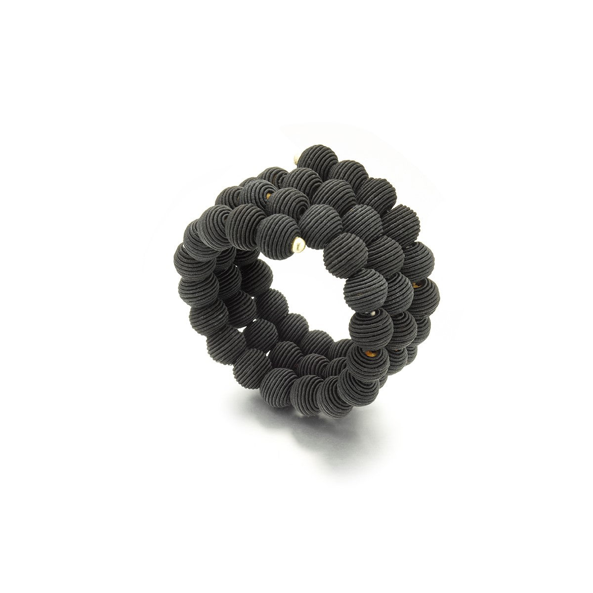 Black beaded bracelet; three rows of textured spherical beads spiral into a ring.