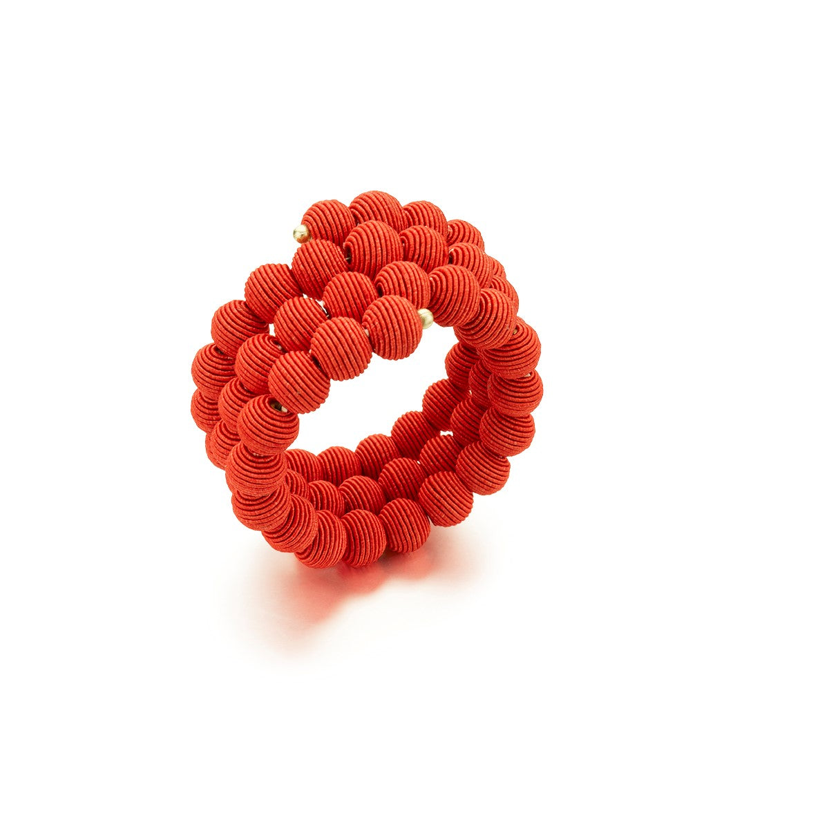 Red fabric bracelet coiled into a circular shape.  The bracelet is composed of many small, textured spheres.
