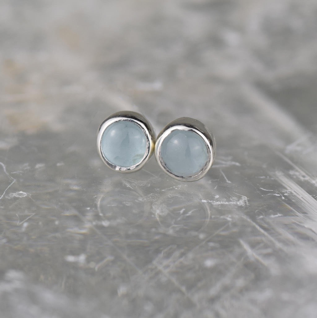 Pair of aquamarine stud earrings with silver settings.