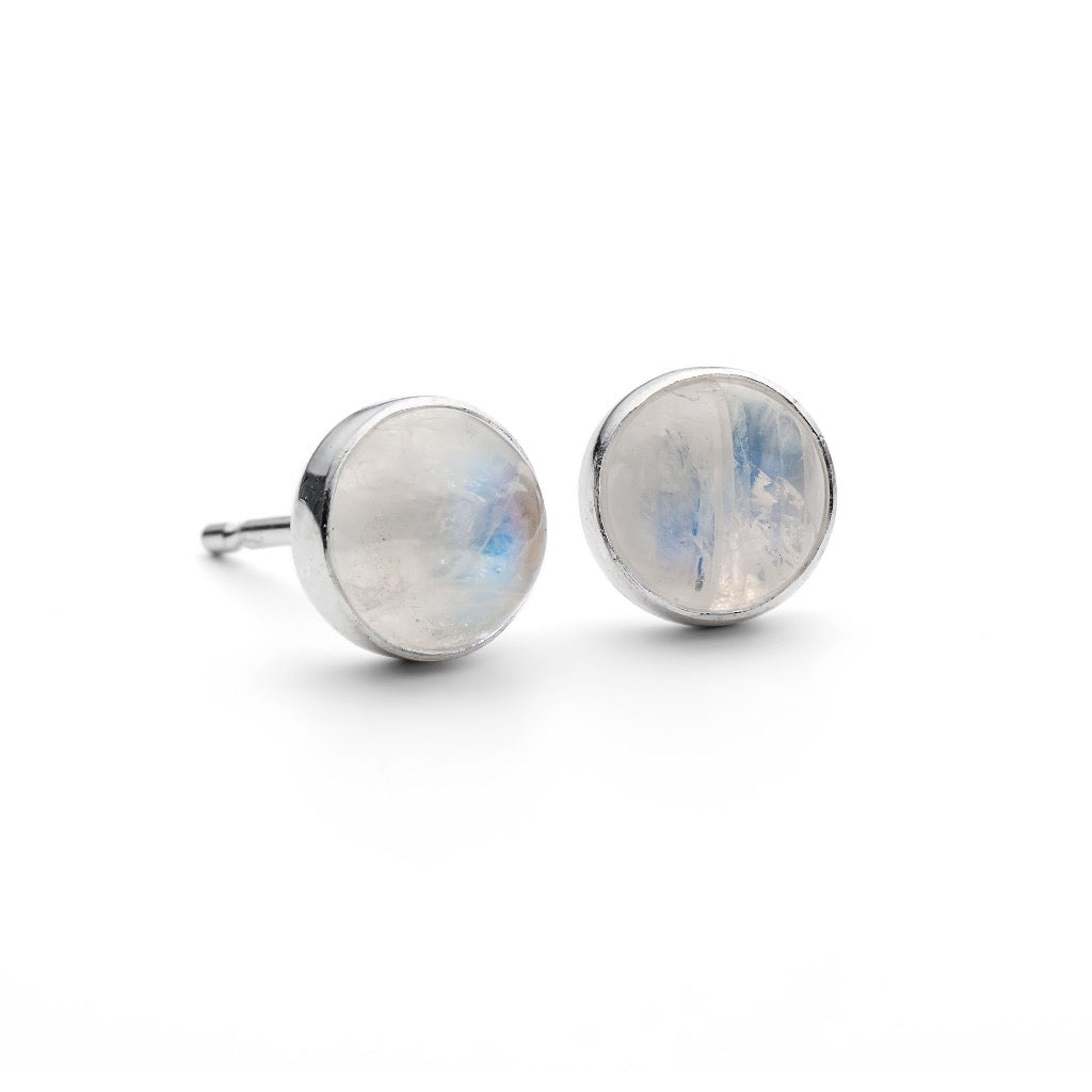 Pair of round moonstone stud earrings in silver settings.