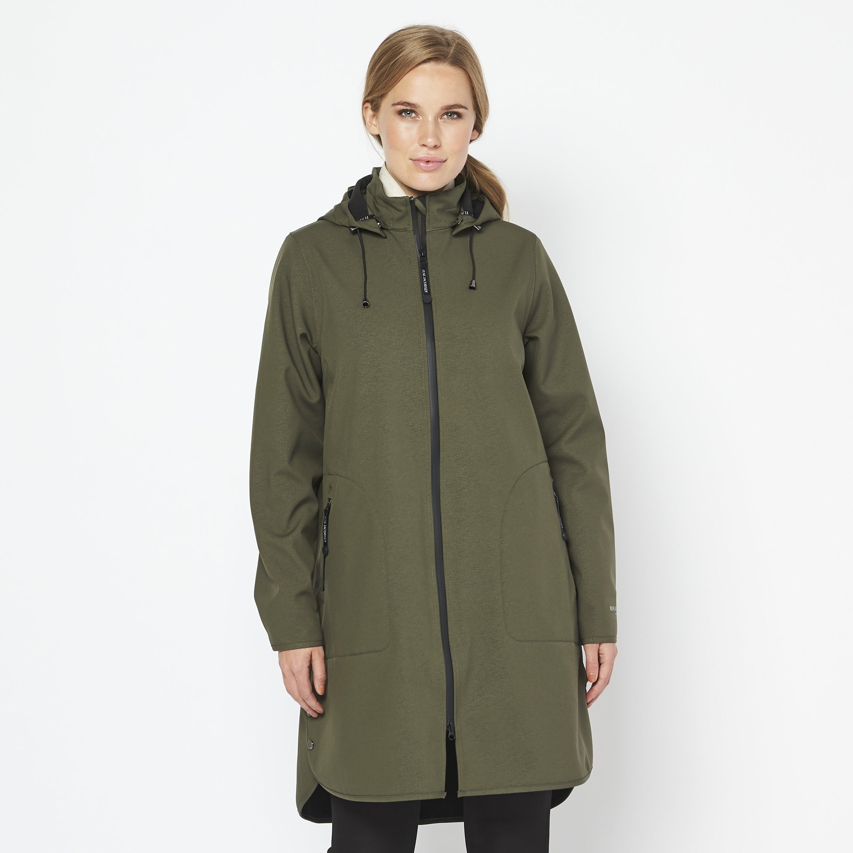 Olive green, long-sleeved hooded raincoat with black zipper and subtle texture. Model showcases the fit and style against a