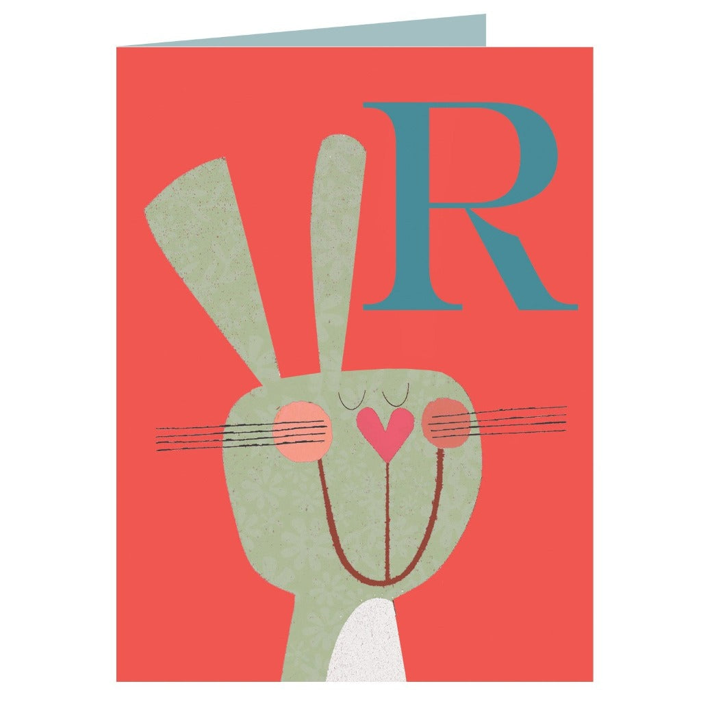 Greeting card featuring a stylized illustration of a rabbit's face and the letter R on a coral background.