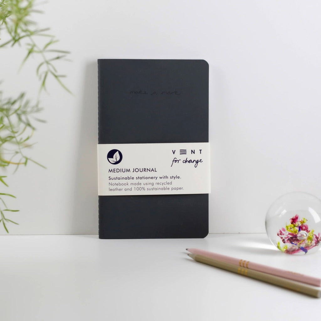 Dark gray, medium-sized journal made from recycled leather and sustainable paper.  "Vent for change" branding visible.