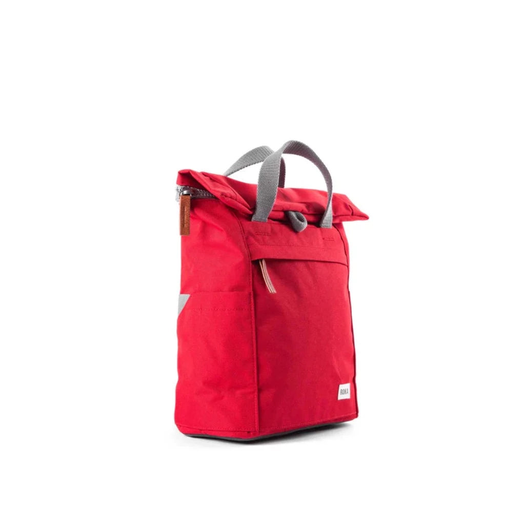 Red roll-top backpack with gray handles and accents. Features a zipper closure and exterior pocket.