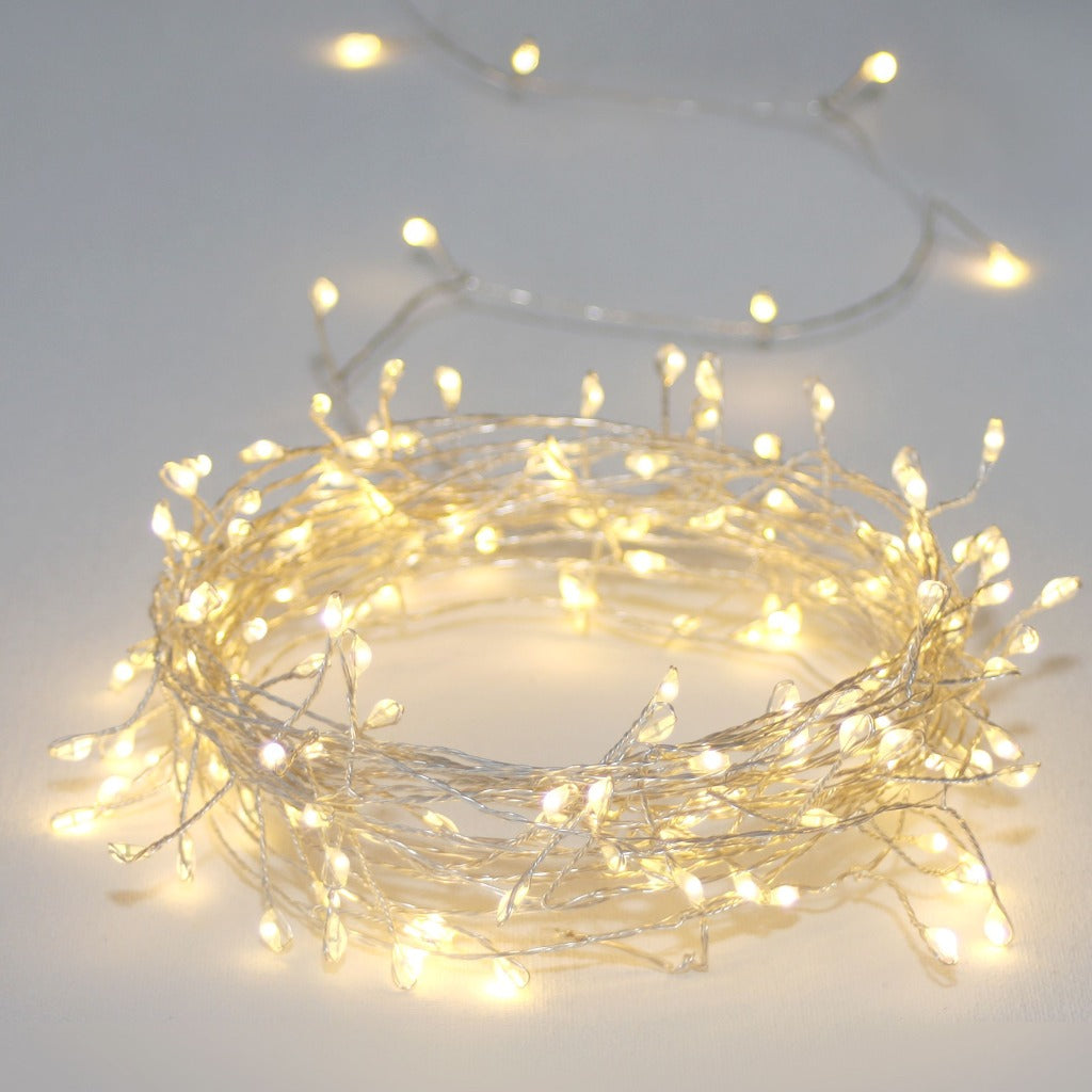 Silver wire string lights with warm white LED bulbs, coiled into a circle.