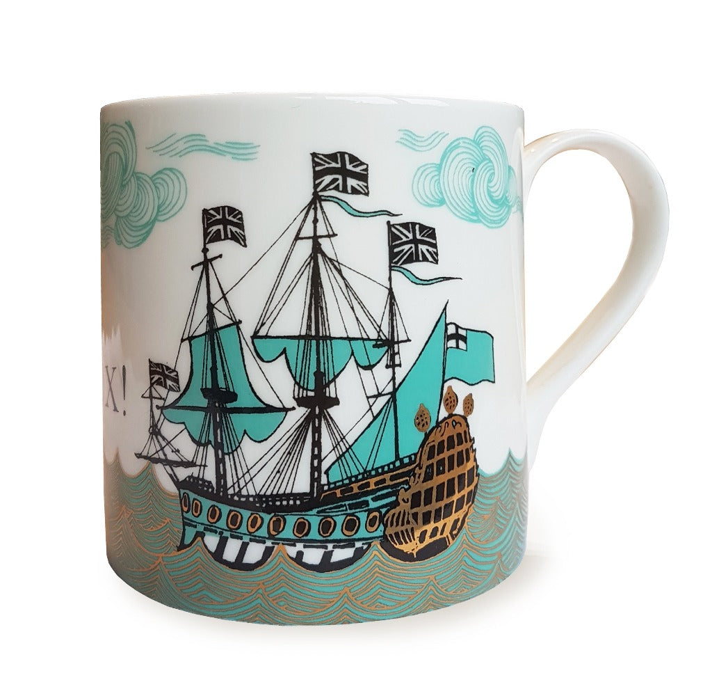White mug featuring a teal and gold illustration of a large sailing ship on the sea.
