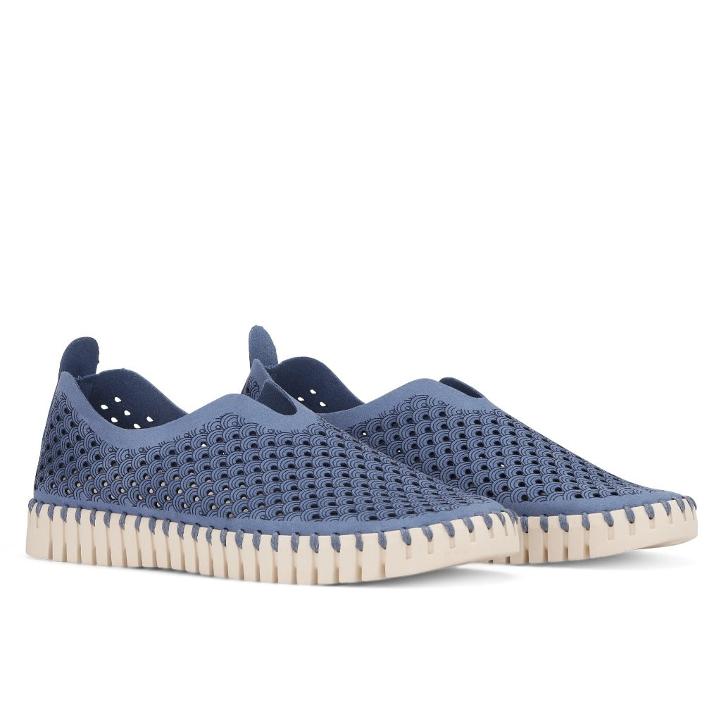 Pair of blue slip-on shoes with a textured, perforated pattern and off-white sole.