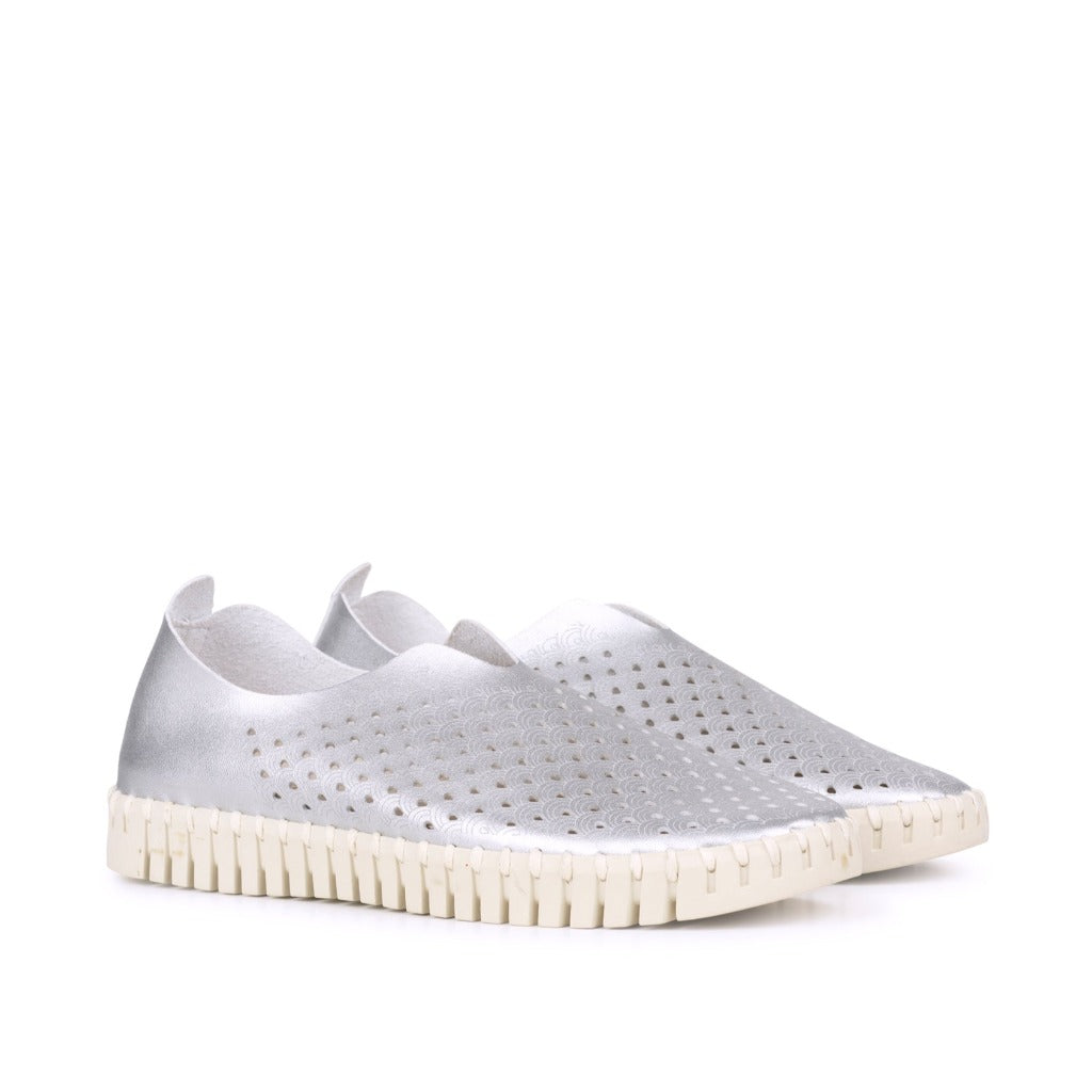 Pair of silver leather slip-on shoes with perforated pattern and cream-colored sole.