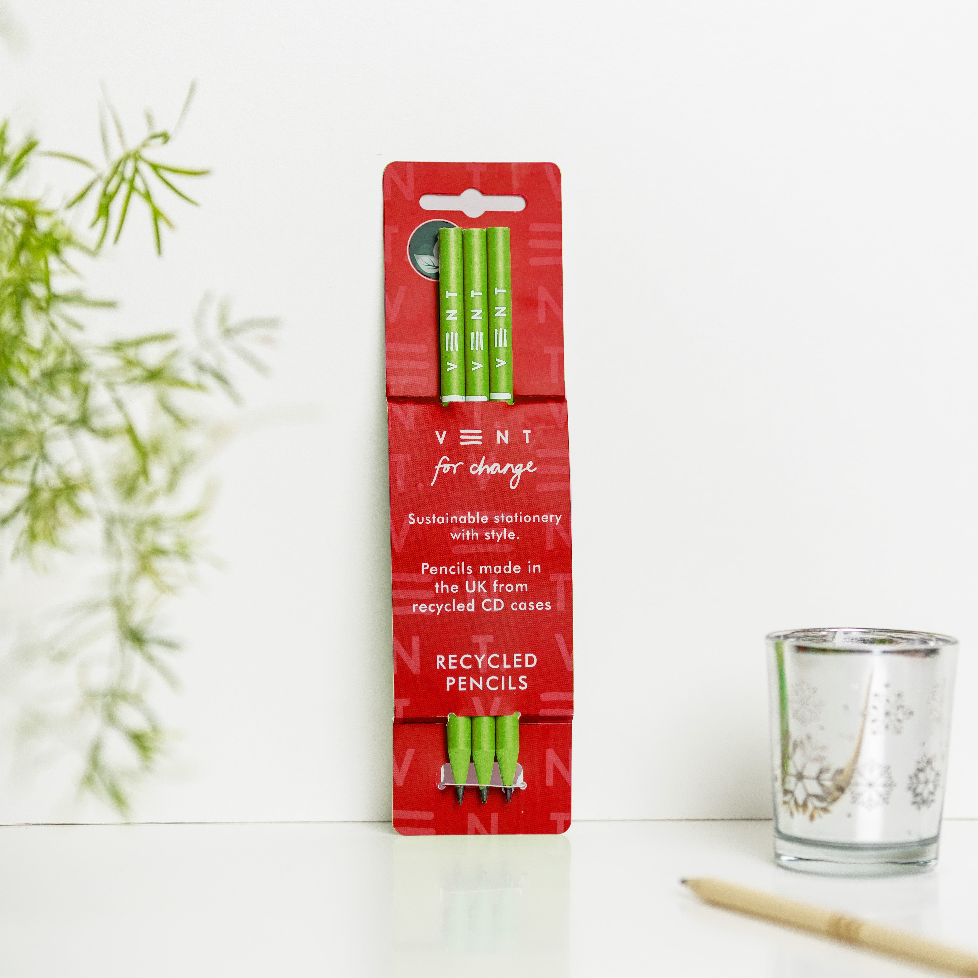Three lime green recycled pencils in a red cardboard package.  Pencils are made in the UK from recycled CD cases.
