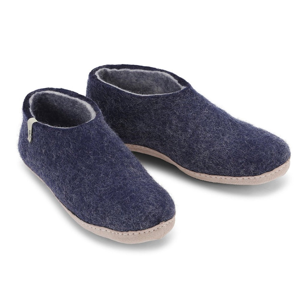 Pair of navy blue wool felt slippers with a light beige sole.