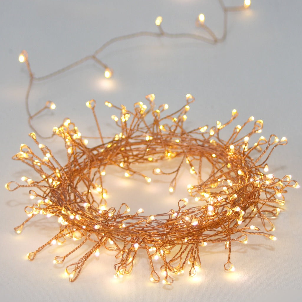 Copper wire string lights with warm white LED lights arranged in a loose circle.