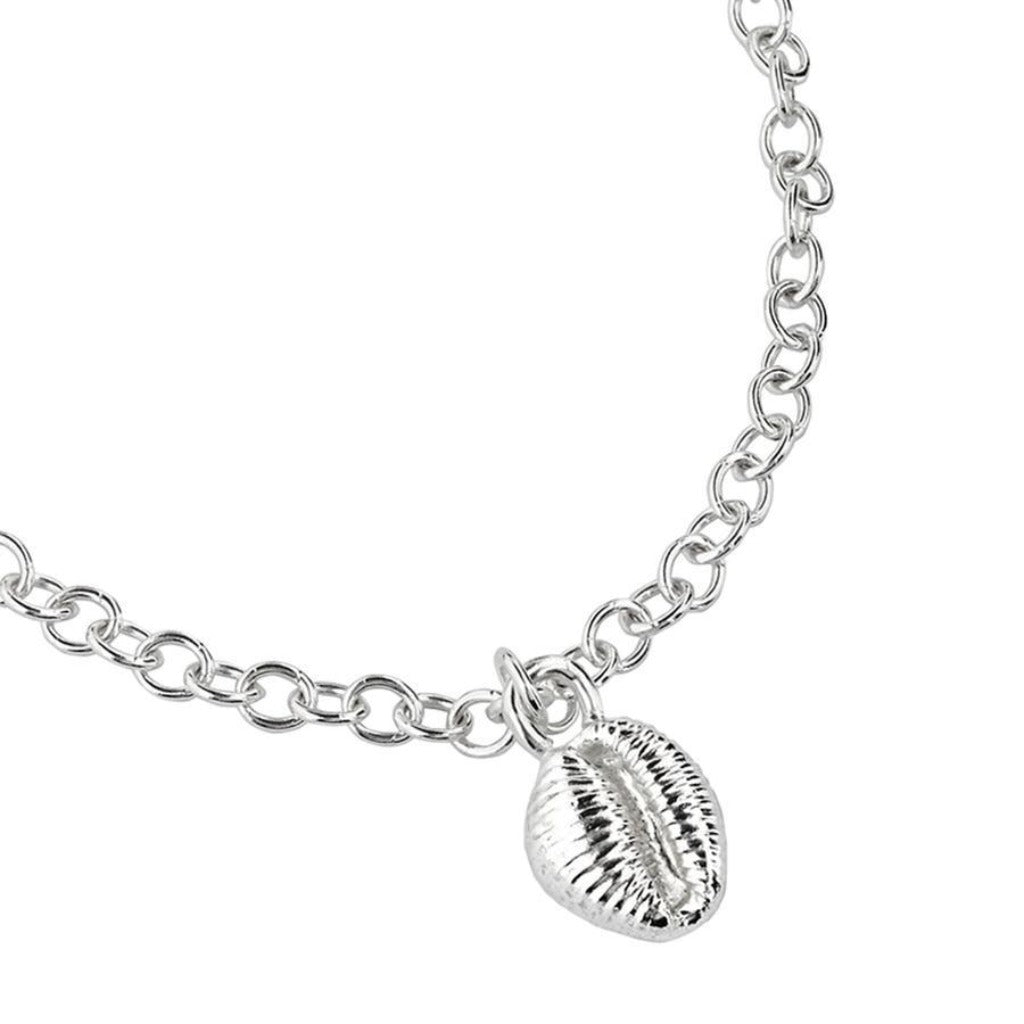 Silver chain bracelet with a detailed shell charm.