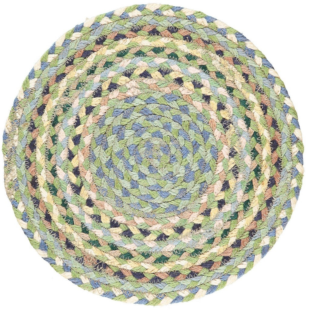 Round braided jute rug in shades of green, blue, and beige.