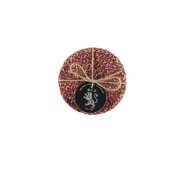 Round burgundy and cream textured coaster with jute twine and a small black label featuring a lion emblem.