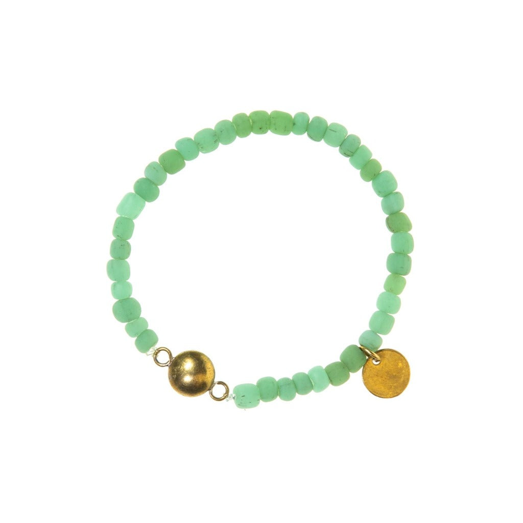 Light green beaded bracelet with gold-toned ball and disc accents.