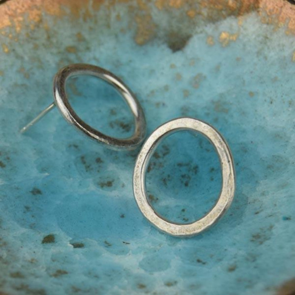 Pair of silver circle stud earrings with a hammered texture.