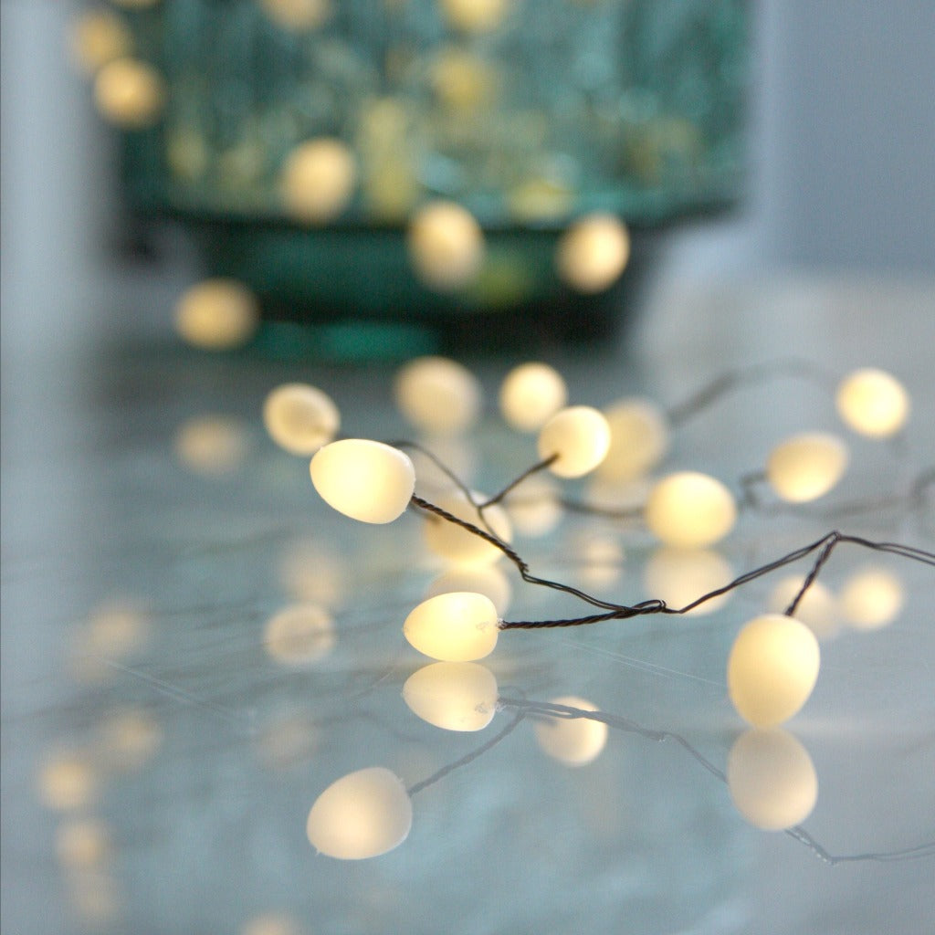 String of warm-white, egg-shaped LED lights on thin wire.