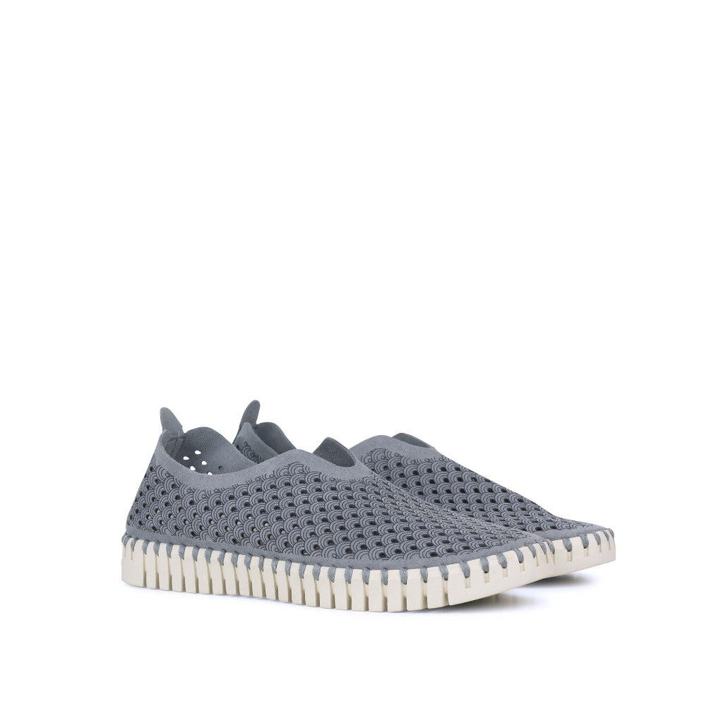 Pair of gray slip-on shoes with a textured, perforated upper and a white, ridged sole. The pattern is a repeating dark gray wave