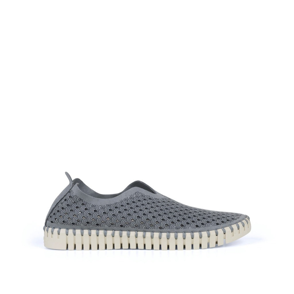 Gray slip-on shoe with textured, perforated upper and off-white, ridged sole.